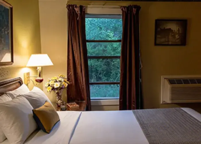 Outpost Motel guest room with warm lamp light